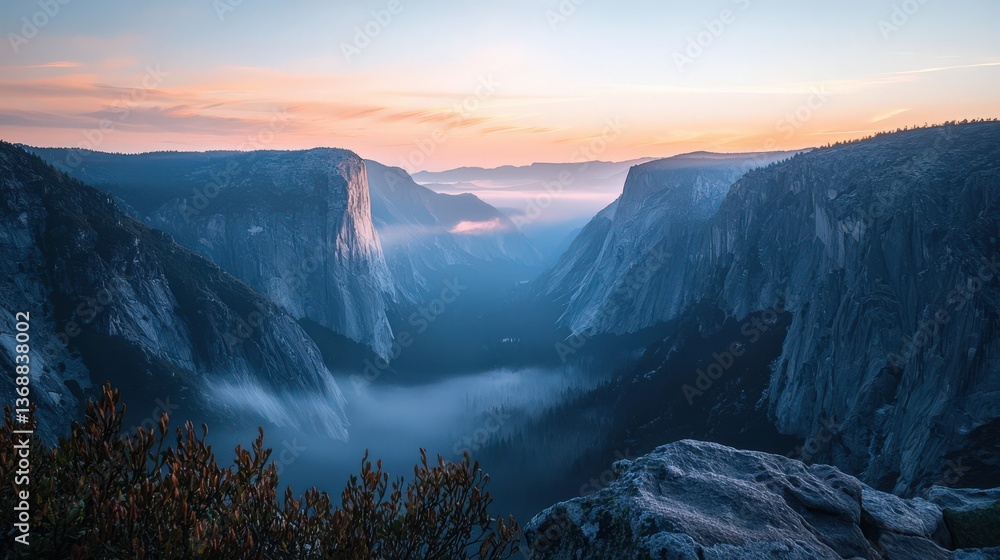 Obraz premium Misty valley sunrise with towering cliffs and vibrant sky - serene landscape