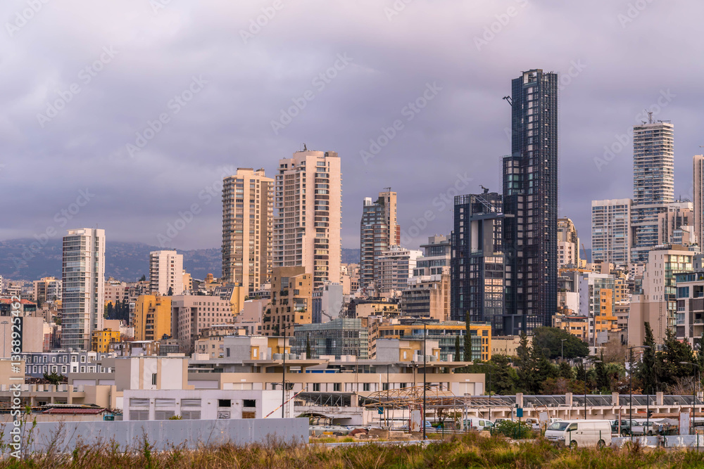 Fototapeta premium Panoramic view of Beirut, Lebanon, showcasing downtown and districts Dekwaneh, Mansourieh, Daychouniyeh, and Sabtiyeh with an urban skyline. 