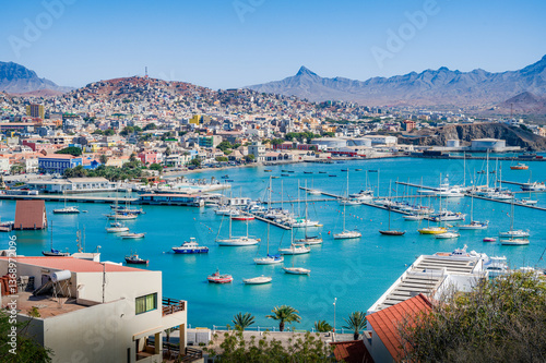 Aerial view of vibrant and colorful day over Mindelo city, and its cove full of ships at docks, Sao Vicente island, Cape Verde