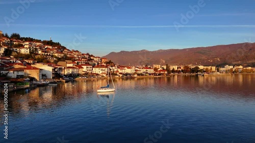 Flying over Lake Ohrid towards the Old Town of Ohrid with a sailboat in the water