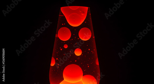Captivating red lava lamp with floating blobs in a darkened ambiance creates a retro vibe