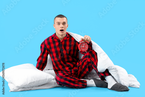 Shocked young man in pajama...