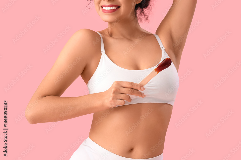 Naklejka premium Beautiful woman with sugaring paste on pink background