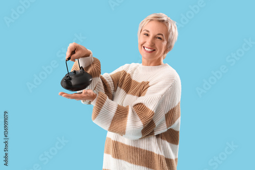 Mature woman with teapot on...