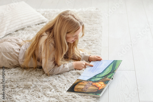 Little girl reading book wh...