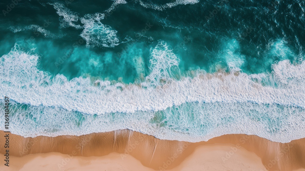 Obraz premium Aerial view of waves crashing on a sandy beach with turquoise water.