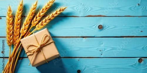 Rustic Gift Presentation with Golden Wheat Stalks on a Blue Wooden Surface