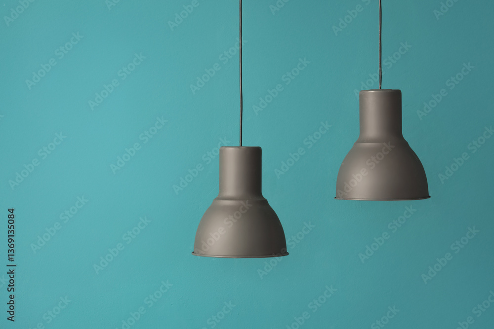 Black modern pendant lamps on blue background