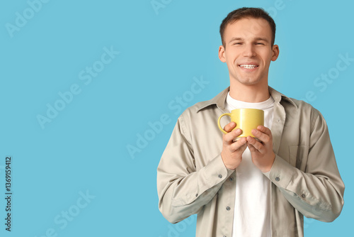 Young man with cup of coffe...