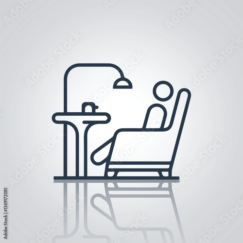 The man is sitting on the sofa in front of the table and a top light, with a silver background