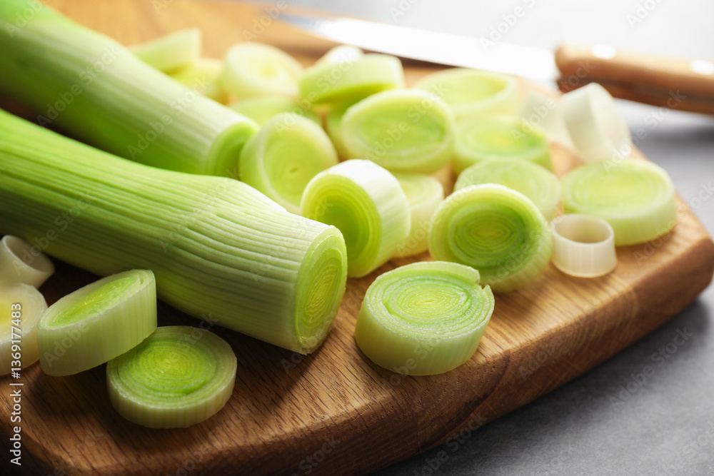 Chopped leeks and knife on grey table, closeup Chopped leeks and knife on grey table, closeup