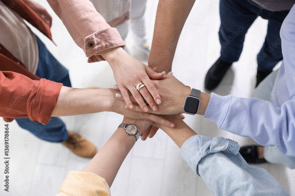Unity concept. People holding hands together indoors, closeup Unity concept. People holding hands together indoors, closeup