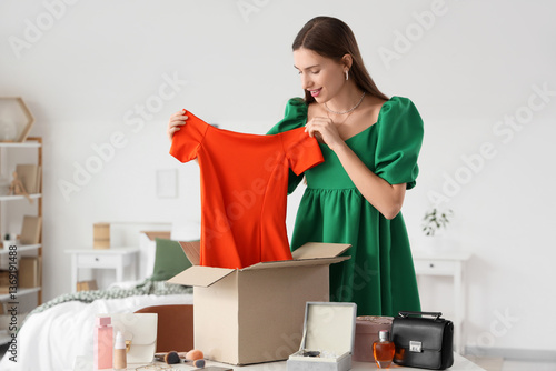 Young woman unboxing new or...