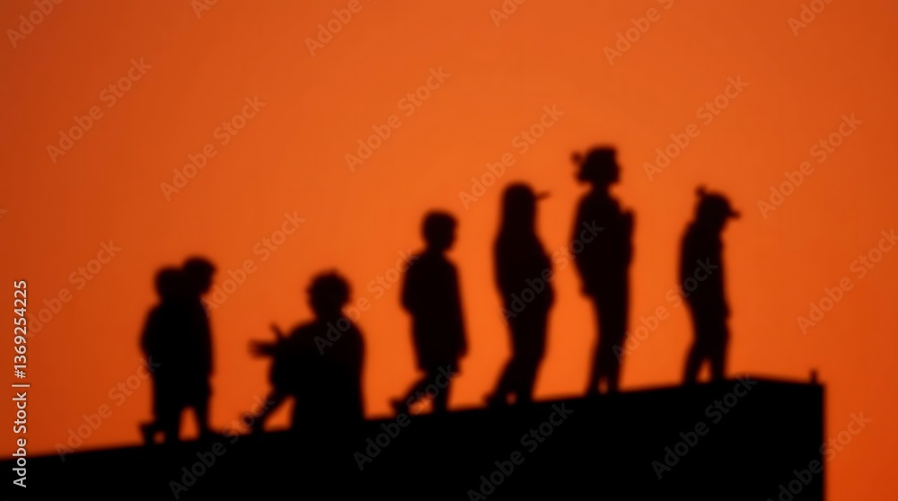 Silhouetted children on rooftop at sunset Silhouetted children on rooftop at sunset