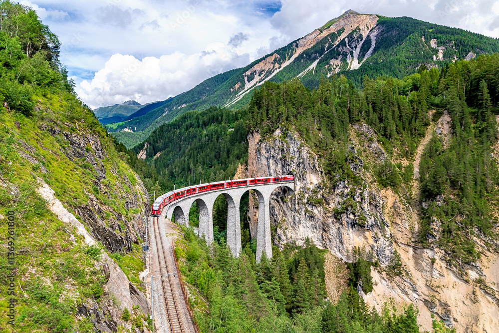 A Rhaetian Railway train crossing the Landwasser Viaduct at Grisons in Switzerland