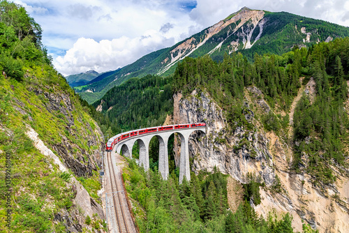 Obraz na płótnie A Rhaetian Railway train crossing the Landwasser Viaduct at Grisons in Switzerland w salonie