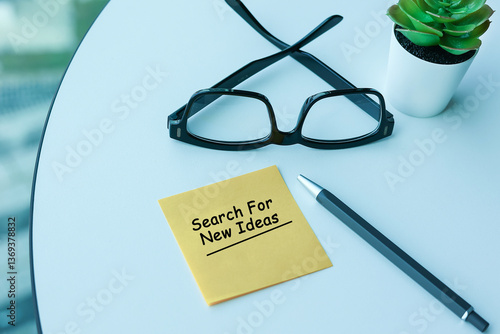 Top view of a yellow colored piece of paper with the word 