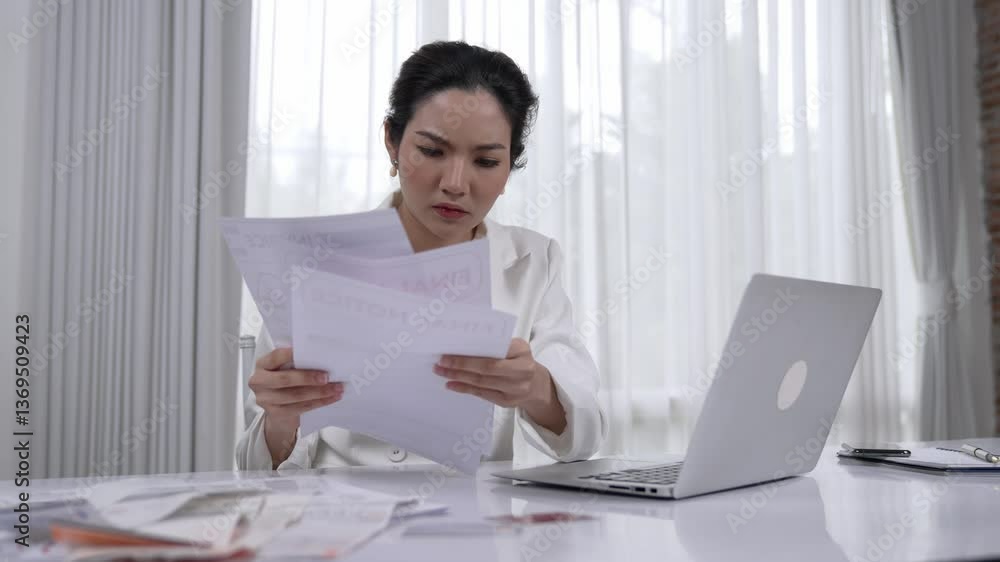 Stressful businesswoman looking at debt bill invoice notification, faces bankruptcy due to overwhelming debt, expenses and economic crisis from bad corporate financial and loan pay management. Vivancy Stressful businesswoman looking at debt bill invoice notification, faces bankruptcy due to overwhelming debt, expenses and economic crisis from bad corporate financial and loan pay management. Vivancy