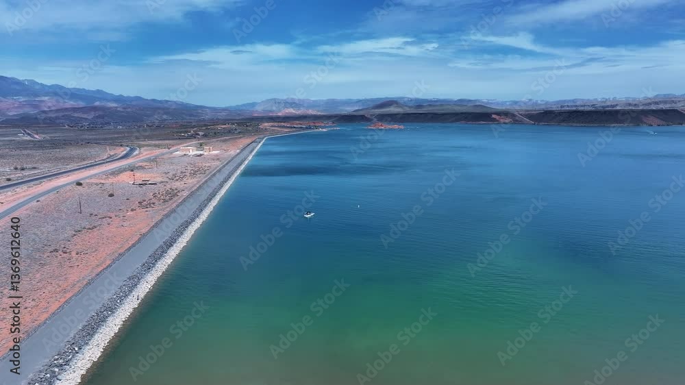 Aerial Sand Hollow lake Utah dam fishing boat. Desert sandy beach and rock dam for sport and water storage. Red sandstone, dirt, sand trails. Outdoor extreme 4x4 recreation ride adventure. Family fun. Aerial Sand Hollow lake Utah dam fishing boat. Desert sandy beach and rock dam for sport and water storage. Red sandstone, dirt, sand trails. Outdoor extreme 4x4 recreation ride adventure. Family fun.