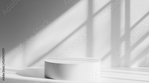 Minimalist white pedestal casting shadows in bright space creates serene atmosphere