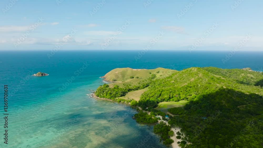 Idyllic tropical coastline with clear blue sea, lush green landscape, and distant hills. Tablas Island, Romblon, Philippines. Idyllic tropical coastline with clear blue sea, lush green landscape, and distant hills. Tablas Island, Romblon, Philippines.