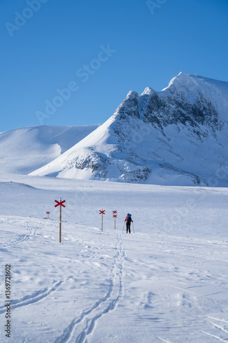 Obraz na płótnie Woman cross-country skiing toward mountain Templet, in the Sylarna mountain range. Sweden. w salonie