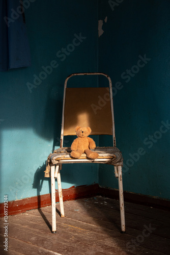 Canvas Print Brown soft teddy bear sitting on a chair in an old abandoned house in Ukraine fo