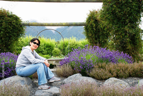 Obraz na płótnie Woman sitting among lavender flowers. Otago. New Zealand. w salonie