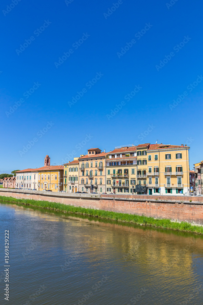 Colorful houses at the quayside of the Arno river in Pisa, Italy