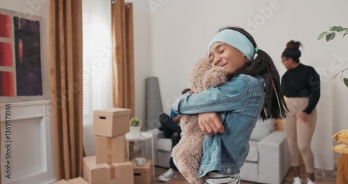 Konstfotografi A little girl helps her parents unpack boxes
