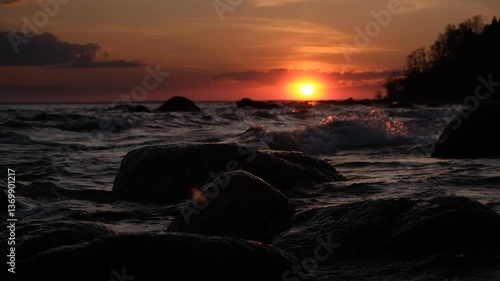 Rocky shore with sea surf at sunset