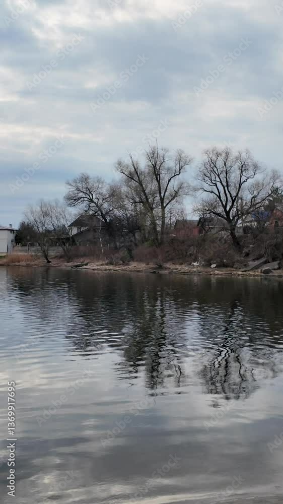 Landscape on the lake shore. Reflection in the river. Sandy bank of the river and dark water. Natural landscape. Walk by the sea. Small waves on the water. Landscape on the lake shore. Reflection in the river. Sandy bank of the river and dark water. Natural landscape. Walk by the sea. Small waves on the water.