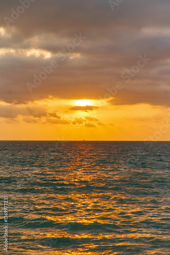 orange sunset is reflected in the blue sea of thailand