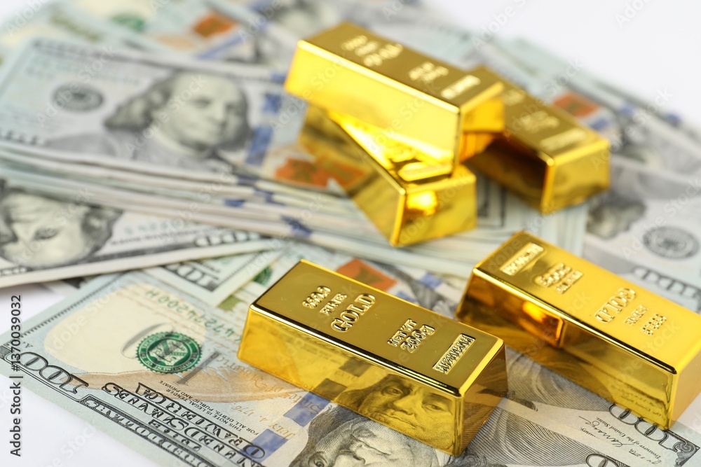 Shiny gold bars and dollar banknotes on table, closeup Shiny gold bars and dollar banknotes on table, closeup