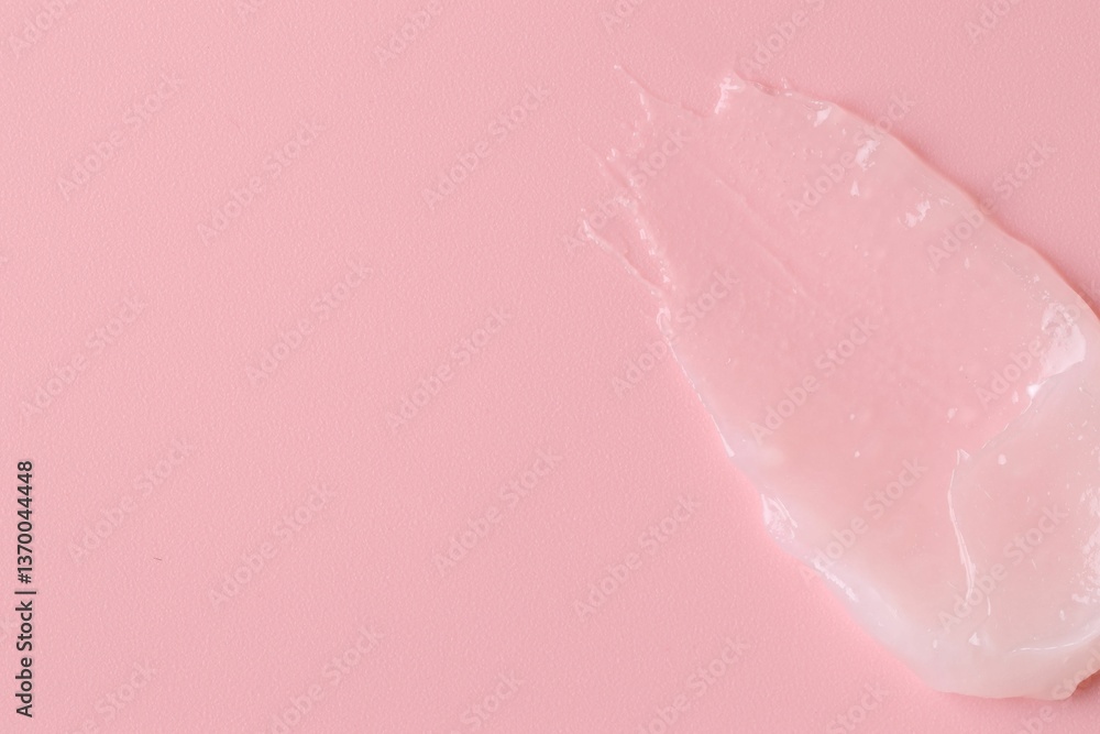 Fototapeta premium Moisturizing lip balm on pink background, top view. Space for text