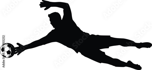 Soccer player diving for a football in a black and white silhouette action scene