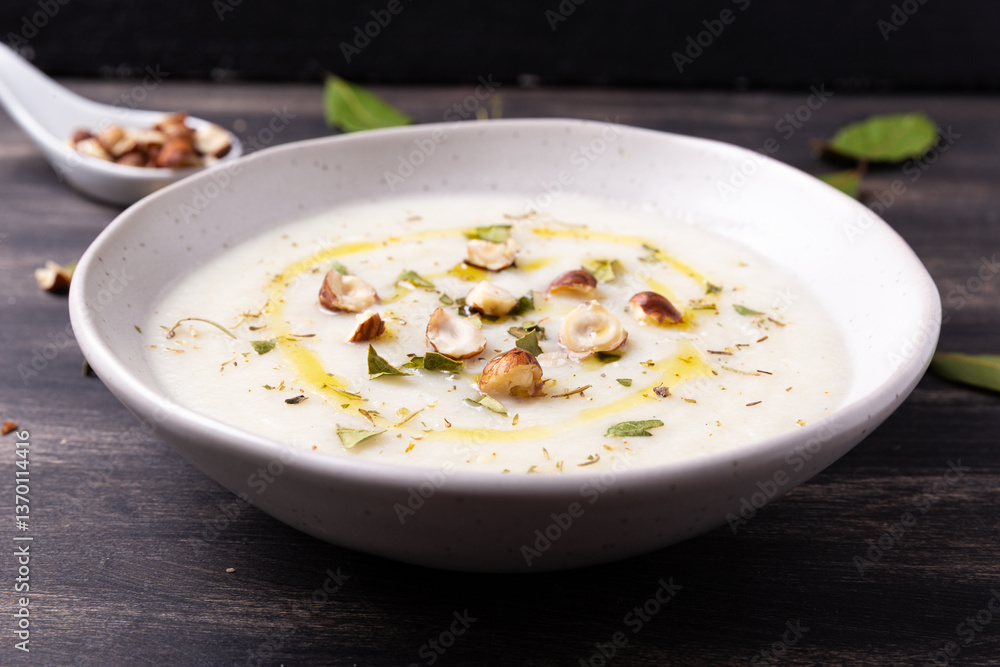 Cauliflower soup with hazelnuts and aromatic herbs. Wnter comfort food and plant based. Cauliflower soup with hazelnuts and aromatic herbs. Wnter comfort food and plant based.