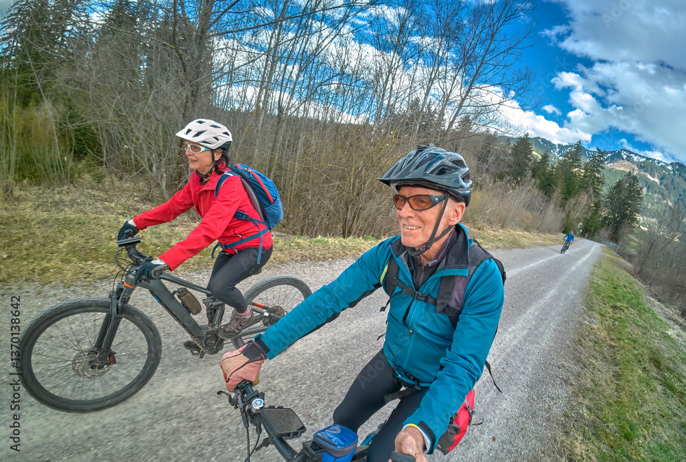 nice senior couple cycling in spring and having fun nice senior couple cycling in spring and having fun