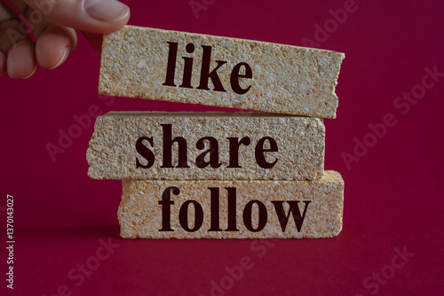 Like share follow symbol. Concept words Like Share Follow on beautiful brick blocks. Beautiful red background. Businessman hand. Business like share follow concept.