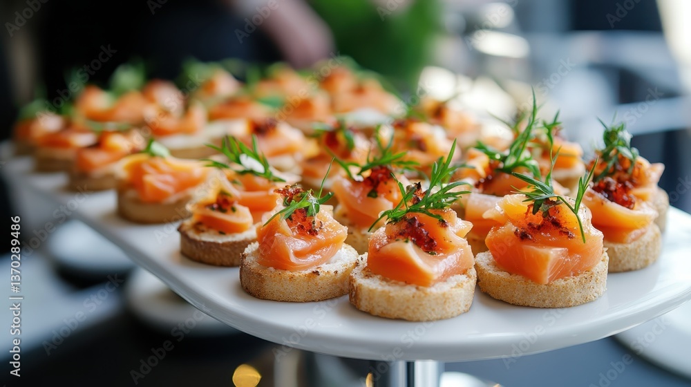 Small toast with smoked salmon, cream cheese, herbs and spices, catering service offering finger food during a business meeting or a wedding reception Small toast with smoked salmon, cream cheese, herbs and spices, catering service offering finger food during a business meeting or a wedding reception