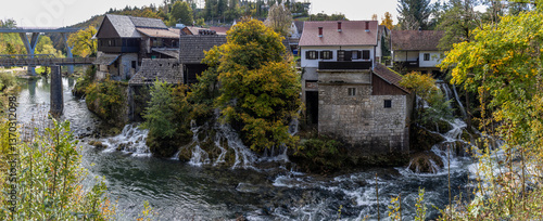 Panoramic photograph of the Rastoke Waterfalls, where the Slunjčica River meets the Korana River, creating a dreamlike landscape. Rastoke, Croatia