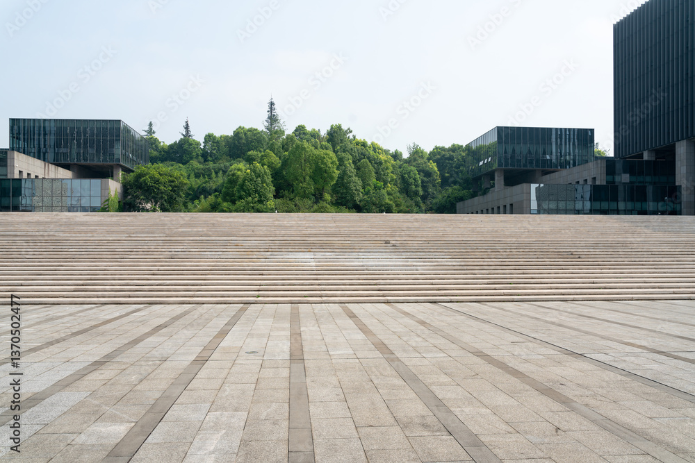 Obraz premium empty concrete ground in front of modern office buildings in downtown. floor for copy space