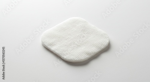 Sterile white gauze pad against plain background for wound care visuals