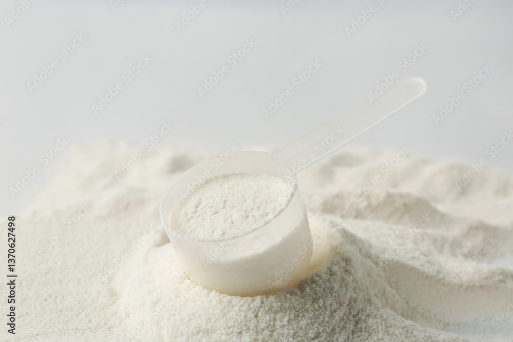 Collagen powder and scoop on light background, closeup