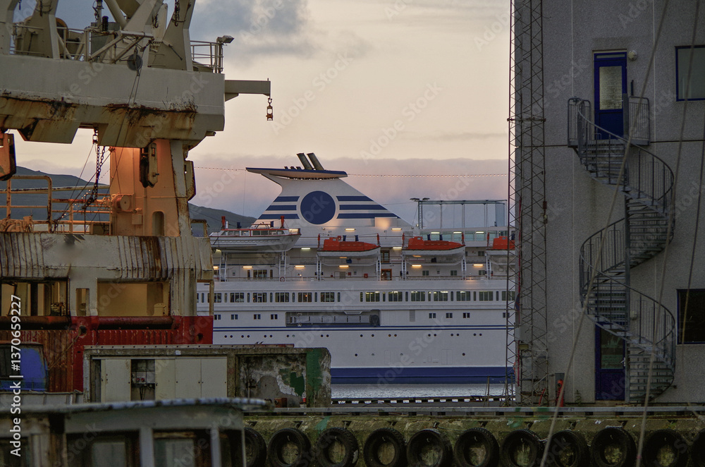 Classic expedition cruiseship cruise ship liner Delphin docked at terminal in Thorshavn Thorshaven, Faroe Islands with city skyline fjord landscape in background during Arctic Circle summer cruising