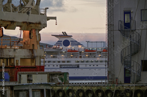 Obraz na płótnie Classic expedition cruiseship cruise ship liner Delphin docked at terminal in Thorshavn Thorshaven, Faroe Islands with city skyline fjord landscape in background during Arctic Circle summer cruising w salonie