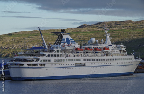 Obraz na płótnie Classic expedition cruiseship cruise ship liner Delphin docked at terminal in Thorshavn Thorshaven, Faroe Islands with city skyline fjord landscape in background during Arctic Circle summer cruising w salonie