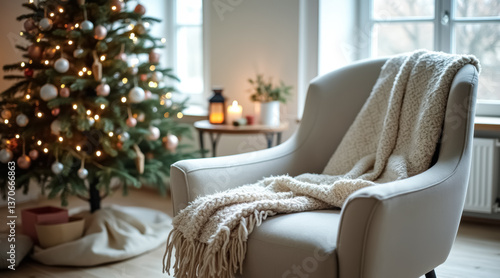 cozy armchair with cream knitted throw near decorated christmas tree