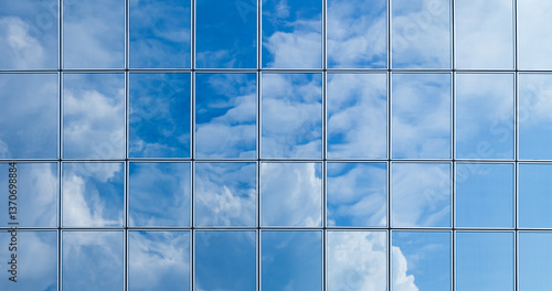 Fototapeta Naklejka Na Ścianę i Meble -  Sky and clouds reflection on the glass facade of modern building, glass facade of a skyscraper background