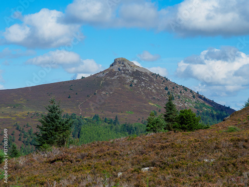 Idyllic view of Mither Tap in the Bennachie Hills, Scotland, showcasing a majestic hilltop surrounded by natural greenery under a bright, clear sky on a picturesque day - Aberdeenshire, UK